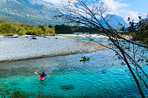 Kayaker in the  Soca river, Soca Valley, Julian Alps, Bovec, Slovenia, October.