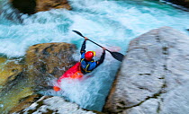 Kayaker going through rapids, Soca river, Julian Alps, Bovec, Slovenia, October 2014.
