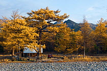 Ranger's house next to Lake Baikal, with mountains behind, 'Brown Bear Coast', Baikalo-Lensky Nature Reserve, Siberia, Russia, September 2013. Completed
