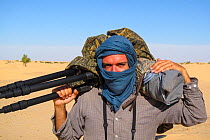 Italian photographer Bruno D'Amicis on assignment to photograph Fennec foxes (Vulpes zerda) protected against sandstorms while working in the field. Tunisia, May 2012