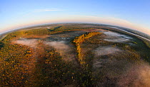 Aerial fish-eye view of a foggy bog with mineral islands at sunrise, Alam-Pedja Nature Reserve, Tartumaa, Estonia, March 2013.