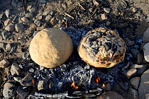 Baking bread on open fire, Malab-Dei village, Danakil Depression, Afar region, Ethiopia, March 2015.