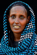 Head portrait of Afar tribe woman with facial tattoo /  skin scarifications and wearing head scarf, Malab-Dei village, Danakil depression, Afar region, Ethiopia, March 2015.
