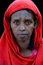 Head portrait of Afar tribe woman with facial tattoos / skin scarifications and wearing a head scarf, Malab-Dei village, Danakil depression, Afar region, Ethiopia, March 2015.