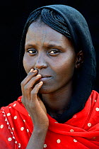 Head portrait of Afar tribe woman with facial tattoo / skin scarifications and wearing a head scarf, Malab-Dei village, Danakil depression, Afar region, Ethiopia, March 2015.