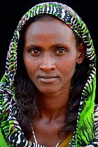 Head portrait of Afar tribe woman with facial tattoos / skin scarifications and wearing a scarf, Ahmed Ela village, Danakil depression, Afar region, Ethiopia, March 2015.