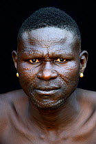 Toposa tribe man dwith elaborate facial skin scarifications, Omo Valley, Ethiopia, March 2015.