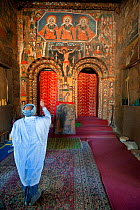 Old Ethiopian man praying (making the cross sign with his hand) inside Debre Birhan Selassie (Trinity and Mountain of Light) Church in the outskirts of Gondar, Amhara Region, Semien Gondar Zone, Ethio...
