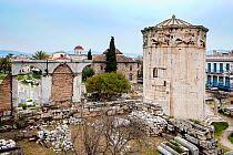 Tower of the Winds or the Horologion of Andronikos Kyrrhestes, with  Cypress Tree (Cupressus sempervirens), and the Fethiye Mosque among the ruins of the Roman Agora. Athens, Greece, Mediterranean, Ja...