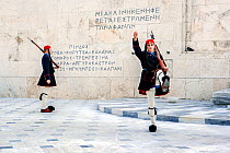 Two soldiers from the Greek Tomb of the Unknown Soldier, the Presidential Mansion and the gate of Evzones camp in Athens. Attica region, Athens, Greece, December 2013