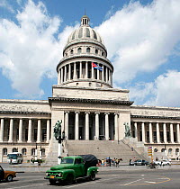 El Capitolio,  National Capitol Building in Havana, Cuba, with a very old green American car parked in front. Havana, Cuba, April 2008.