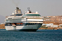 Cruise ship from 'Celebrity Cruises' anchored outside Mykonos Town since it is unable to enter the harbor due to its size. Mykonos Island, Cyclades, Aegean Sea, Mediterranean, Greece, August 2007.