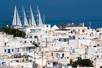 White houses in Mykonos Town with luxury ship Wind Star in the background. Mykonos Island, Cyclades, Aegean Sea, Mediterranean, Greece, August 2007