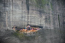 Meteora rock near to village of Kastraki. The scarves are hung at the entrance to the cave. Every year, on St. George's day, people climb the rock and hang new scarves that will stay there for a year...