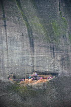 Meteora rock near to village of Kastraki. The scarves are hung at the entrance to the cave. Every year, on St. George's day, people climb the rock and hang new scarves that will stay there for a year...