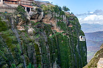 Tourist using a cable car to visit the Holy Monastery of Great Meteoron. This is the largest of the monasteries located at Meteora built in the mid-14th century. Meteora, Kalambaka, Thessaly Region, G...