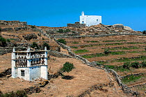 Tinos Dovecotes. with Greek Orthodox Church in background. The island of Tinos is famous for its many intricately designed dovecotes. Tinos island, Cycladic islands, Aegean Sea, Greece, Mediterranean,...
