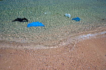Plastic litter on beach near Mykonos town. Mykonos island, Cyclades, Aegean Sea, Mediterranean, Greece, August 2007.