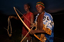 Men paid to guard field from African elephants (Loxodonta africana) and scare them off with bows, slingshots and drums. Due to over population of elephants in this region many are being translocated t...
