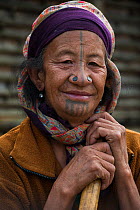 Apatani woman with facial tattoos and traditional nose plugs / Yapin Hulo made  to make them look unattractive to males from other tribes. These facial modifications are now outlawed. Apatani Tribe, Z...