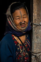 Apatani woman with facial tattoos and traditional nose plugs / Yapin Hulo.These plugs are made of a cane slice. This practice was to make them look unattractive to males from other tribes. These facia...