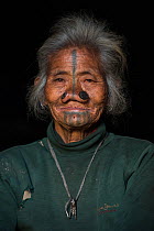 Apatani woman & facial tattoos & nose plugs / Yapin Hulo.These plugs are made of a cane slice. This practice was to make them look unattractive to males from other tribes. These facial modifications a...