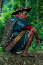 Adi Gallong man wearing traditional cane hat. Adi Gallong Tribe. Arunachal Pradesh, North East India, October 2014.