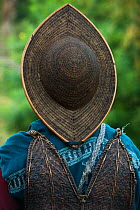 Adi Gallong man wearing traditional cane hat. Adi Gallong Tribe. Arunachal Pradesh, North East India, October 2014.