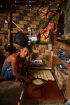 Man making bread in roadside bakery, Nagaland, North East India, October 2014.