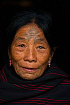 Chang Naga woman with facial tattoos,  Tuensang district. Nagaland, North East India, October 2014.