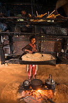 Chang Naga woman cooking,  Tuensang district. Nagaland, North East India, October 2014.