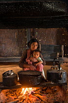 Chang Naga woman with baby, Chang Naga headhunting Tribe. Tuensang district. Nagaland, North East India, October 2014.