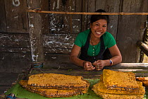 Chang Naga woman with honeycombs for sale. Tuensang district. Nagaland, North East India, October 2014.