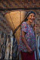Ao Naga woman carrying rice basket, Mokokchung district. Nagaland, North East India, October 2014.