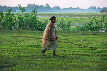 Mising woman with fishing net, Majuli Island, Brahmaputra River. Assam, North East India, October 2014.