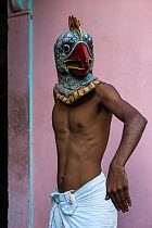 Man wearing bird mask for Raas festival. Mising Tribe, Majuli Island, Brahmaputra River. North East India, October 2014.