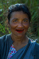 Khasi woman chewing Betel nut, a mild stimulant which leaves red staining on the teeth, Barabazar market, Shillong, Meghalaya, North East India.