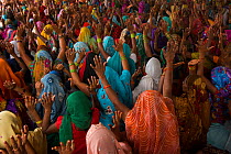 Women with hands raised at religious gathering, Bateshwar Village, Agra District, Uttar Pradesh, India, October 2014.