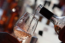 Glass and bottle of wine at wine tasting, la Londe les Maures, Var, France, Provence, August 2015.