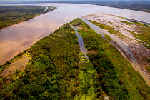 Aerial view of Amazon River, with settlements and secondary rainforest, near Iquitos, Peru. July 2015.