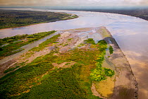 Aerial view of Amazon River, with settlements and secondary rainforest, near Iquitos, Peru. July 2015.