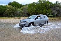 Car fording a river near Paradise, Arizona, USA, September 2013.