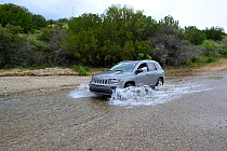 Car fording a river near Paradise, Arizona, USA, September 2013.