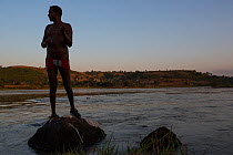 Man fishing on bank of Blue Nile river. Bahir Dar, Lake Tana Biosphere Reserve. Ethiopia. December 2013.