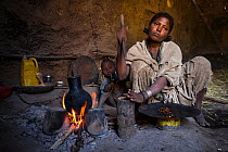 Woman preparing coffee in hut on shores of Shesher lake, Fogera Plains, Lake Tana Biosphere Reserve, Ethiopia. December 2013.