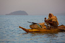Fisherman on traditional Nile grass boat, Lake Tana Biosphere Reserve, Ethiopia. December 2013.