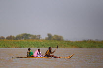 Family moving on Nile grass boats on Lake Tana Biosphere Reserve, Ethiopia. December 2013.