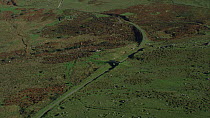 Aerial view tracking over West Moor, with a disused railway line, Dartmoor National Park, Devon, England, UK, October 2015.