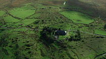 Aerial view tracking over Whiteworks hamlet, showing evidence of past mining, Dartmoor National Park, Devon, England, UK, October 2015.