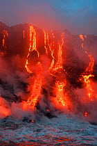 Red hot lava from Kilauea Volcano flowing into ocean at West Kailiili, Hawaii Volcanoes National Park, Big Island, Hawaiian Islands, USA, December 2011.